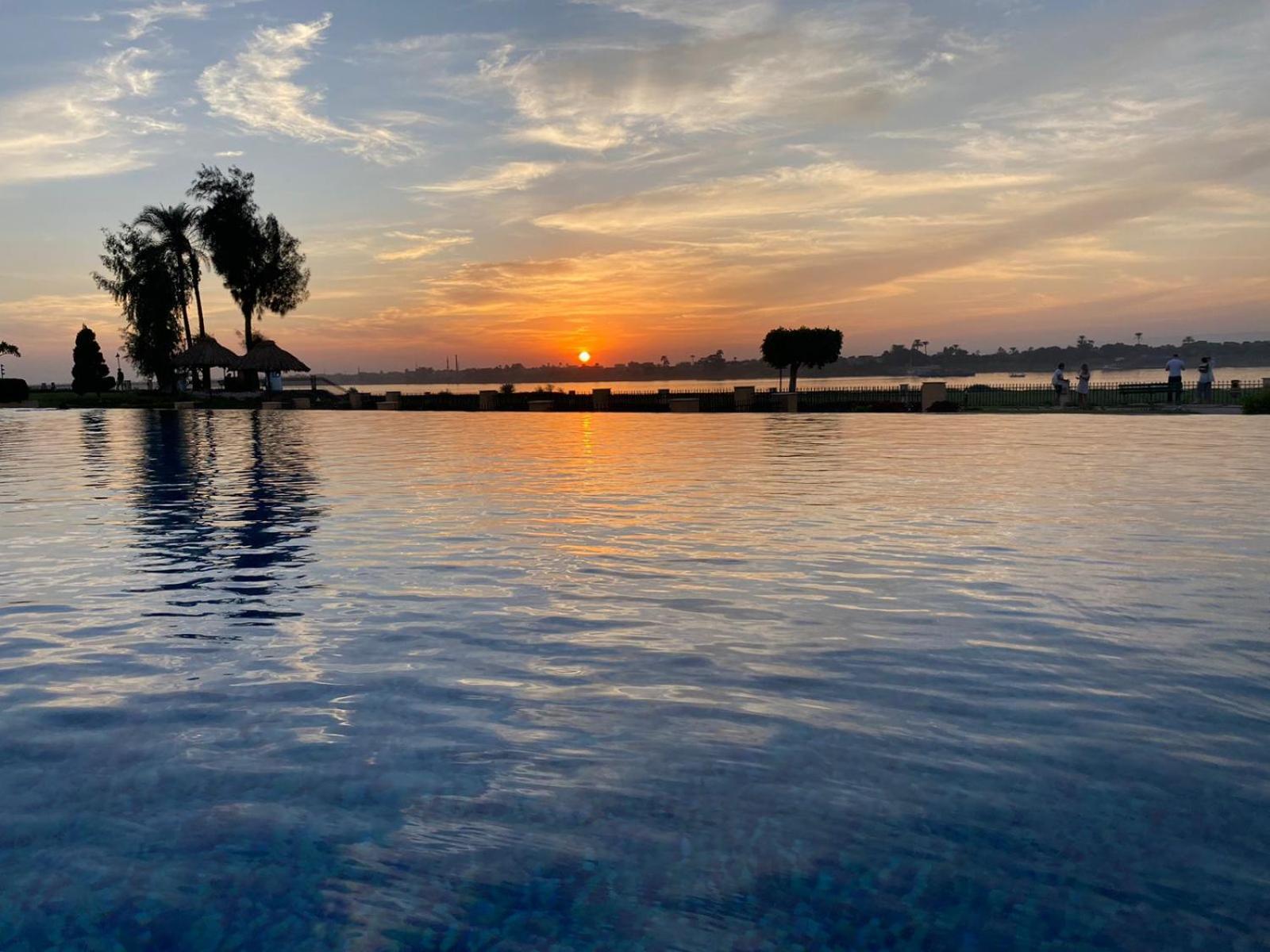 Jolie Ville Hotel & Spa Kings Island Luxor Exterior photo Sunset at the lagoon